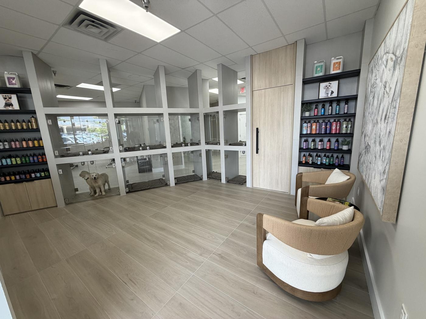 ZenSpawt lobby: oak floors, glass-front suites, boucle chairs and the DOWG product wall